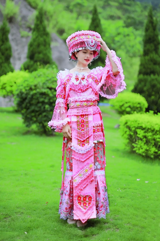 Woman in traditional Lao pink dress